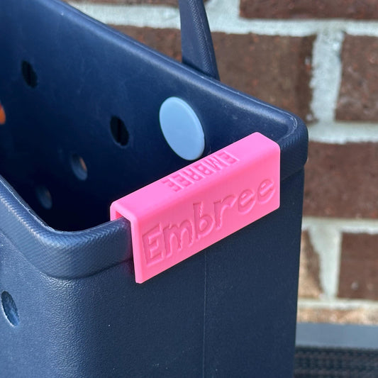 a plastic name plate on a baby bogg page